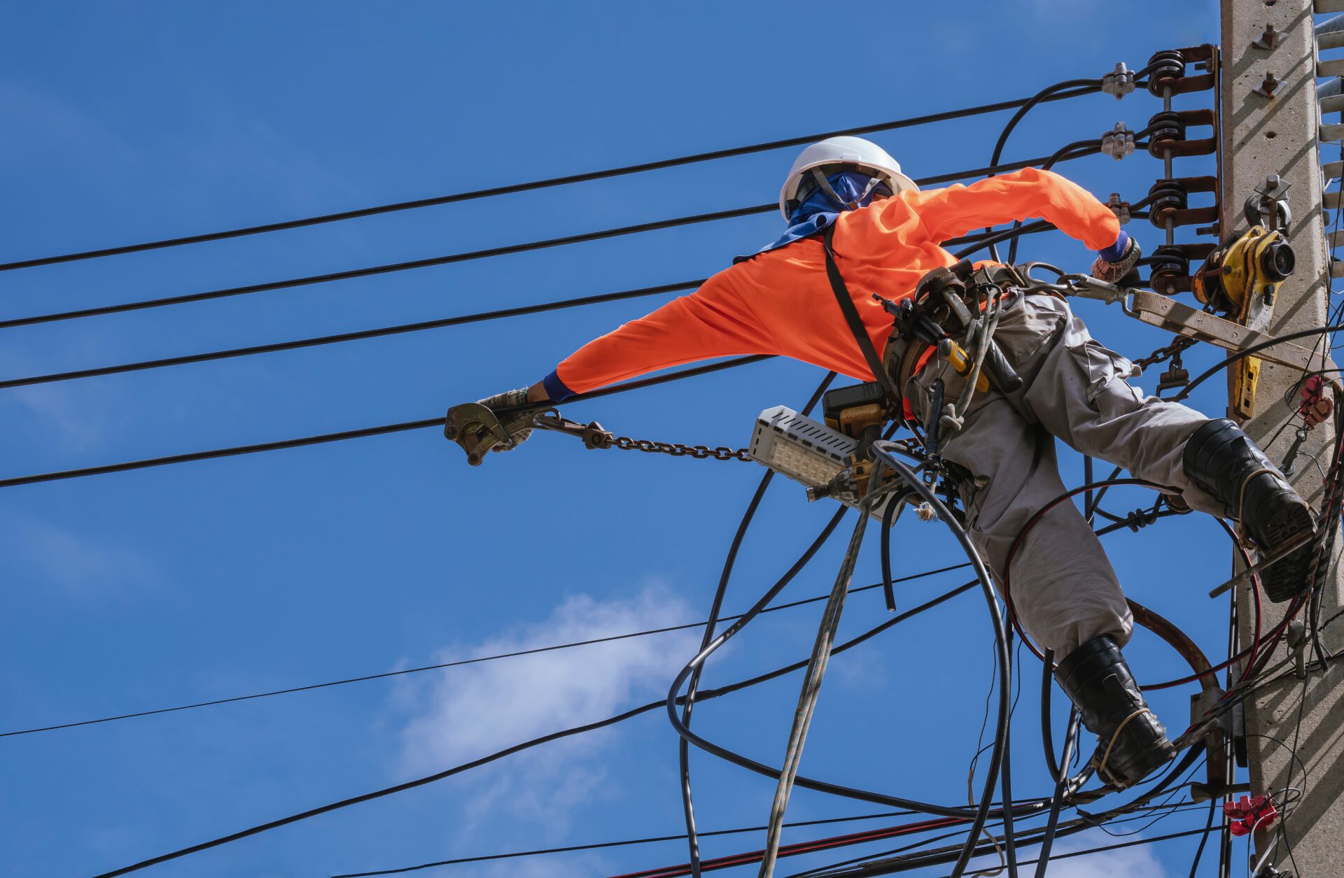 electrician-with-work-tools-is-installing-cable-lines-electrical-system-electric-power-pole